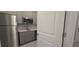 Modern kitchen with gray cabinets, stainless steel appliances, and quartz countertops at 1007 Theodore St, Davenport, FL 33837