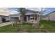 Single-story home with gray siding, landscaping, and a two-car garage at 1007 Theodore St, Davenport, FL 33837