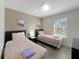 Bedroom with two twin beds, nightstand, and window at 319 Verona Ave, Davenport, FL 33897