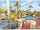 Community pool with water features, a slide, and lush landscaping at 319 Verona Ave, Davenport, FL 33897
