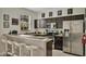 Modern kitchen with stainless steel appliances and breakfast bar at 319 Verona Ave, Davenport, FL 33897