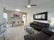 Spacious living room with leather sofas and a large TV at 319 Verona Ave, Davenport, FL 33897