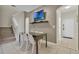 Bright dining area with glass table and four chairs, located near entryway and stairs at 319 Verona Ave, Davenport, FL 33897