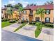 Two-story townhome with brick paver driveway and palm trees at 319 Verona Ave, Davenport, FL 33897