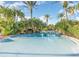 Relaxing community pool with palm trees and a winding design at 319 Verona Ave, Davenport, FL 33897