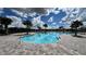 Community pool with plenty of lounge chairs and a large deck at 625 Disa Dr, Davenport, FL 33837