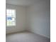 Simple bedroom with large window and neutral carpet at 1648 Andover Ridge Dr, Deland, FL 32720