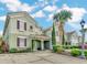 Green two-story townhouse with red shutters and landscaping at 4738 Terrasonesta Dr, Davenport, FL 33837