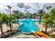Large resort-style pool with a waterslide and palm trees at 4738 Terrasonesta Dr, Davenport, FL 33837
