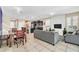 Open concept kitchen and living room with modern appliances and gray sofas at 4738 Terrasonesta Dr, Davenport, FL 33837