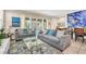 Spacious living room with gray sofas and a large glass coffee table at 4738 Terrasonesta Dr, Davenport, FL 33837