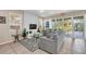 Cozy living room with gray sofas, a glass coffee table, and access to a patio at 4738 Terrasonesta Dr, Davenport, FL 33837