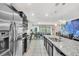 Modern kitchen with island, stainless steel appliances, and granite countertops at 4738 Terrasonesta Dr, Davenport, FL 33837