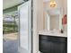 Clean half bathroom with dark vanity and access to the backyard pool at 4738 Terrasonesta Dr, Davenport, FL 33837
