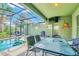 Screened-in pool area with patio furniture and grill at 4738 Terrasonesta Dr, Davenport, FL 33837