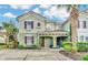 Two-story townhouse with green exterior, red shutters, and a brick walkway at 4738 Terrasonesta Dr, Davenport, FL 33837