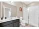 Main bathroom with walk-in shower, toilet, and dark vanity at 4738 Terrasonesta Dr, Davenport, FL 33837