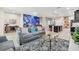 Open living room with gray sofas, coffee table, and views into the kitchen at 4738 Terrasonesta Dr, Davenport, FL 33837
