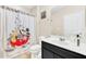 Bathroom with Mickey Mouse shower curtain and dark vanity at 4738 Terrasonesta Dr, Davenport, FL 33837