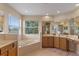 Bathroom with large soaking tub, double vanity, and ample counter space at 23509 Companero Dr, Sorrento, FL 32776