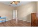 Bedroom with wood floors, ceiling fan, and access to bathroom at 23509 Companero Dr, Sorrento, FL 32776