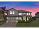 Two-story home with landscaping and three-car garage at 23509 Companero Dr, Sorrento, FL 32776