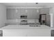 Modern kitchen with gray cabinets, stainless steel appliances, and white quartz countertops at 161 Marion Oaks Trail, Ocala, FL 34473