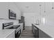 Modern kitchen with gray cabinets and stainless steel appliances at 161 Marion Oaks Trail, Ocala, FL 34473