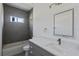 Modern bathroom with gray tile, a white vanity, and a bathtub at 161 Marion Oaks Trail, Ocala, FL 34473