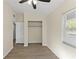 Light bedroom with wood-look floors, closet, and window at 2140 Ridge Dr, Winter Park, FL 32792