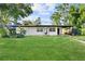 Single story home with a large front yard and driveway at 2140 Ridge Dr, Winter Park, FL 32792