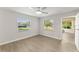 Bedroom with wood-look floors, large windows and access to a sunroom at 2140 Ridge Dr, Winter Park, FL 32792