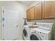 Convenient laundry room with washer, dryer, and cabinets at 1381 Hazeldene Mnr, Deland, FL 32724