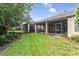 Landscaped backyard with screened porch at 1381 Hazeldene Mnr, Deland, FL 32724