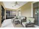Spacious screened porch with wicker furniture at 1381 Hazeldene Mnr, Deland, FL 32724
