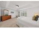 Well-lit bedroom with plush carpeting, dresser, and large window at 8091 Brooksville Dr, Davenport, FL 33896