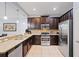 Spacious kitchen with dark wood cabinets and granite countertops at 8091 Brooksville Dr, Davenport, FL 33896