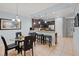 Open concept kitchen and dining area with dark cabinetry, stainless steel appliances, and breakfast bar at 8091 Brooksville Dr, Davenport, FL 33896