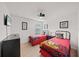 Bright bedroom with two twin beds, nightstands, and wall-mounted TV at 8091 Brooksville Dr, Davenport, FL 33896