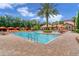 Large community pool with plenty of lounge chairs and umbrellas at 8091 Brooksville Dr, Davenport, FL 33896