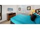Guest bedroom with a queen bed, dresser, and mounted TV at 8091 Brooksville Dr, Davenport, FL 33896