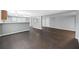 Open living room with kitchen view and dark vinyl flooring at 313 Story Partin Rd, Orlando, FL 32833