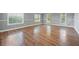 Spacious living area showcasing hardwood floors and large windows at 313 Story Partin Rd, Orlando, FL 32833