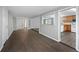 Open concept living space with dark vinyl flooring and neutral walls at 313 Story Partin Rd, Orlando, FL 32833