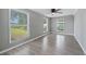 Well-lit bedroom with hardwood floors and ceiling fan at 313 Story Partin Rd, Orlando, FL 32833