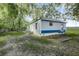 Mobile home with a large backyard and trees at 313 Story Partin Rd, Orlando, FL 32833