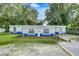 Charming blue house with landscaping and yard at 313 Story Partin Rd, Orlando, FL 32833