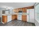 Modern kitchen featuring wood cabinets, stainless steel appliances, and a breakfast bar at 313 Story Partin Rd, Orlando, FL 32833