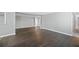Open concept living area with dark vinyl flooring and neutral walls at 313 Story Partin Rd, Orlando, FL 32833