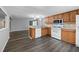 Modern kitchen featuring wood cabinets, white appliances and a breakfast bar at 313 Story Partin Rd, Orlando, FL 32833